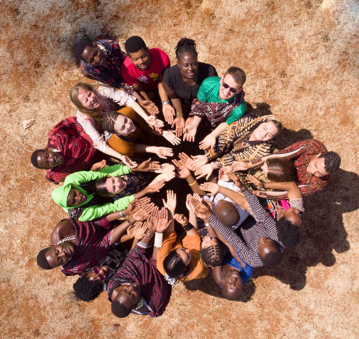 An African community joining hands together in a circle